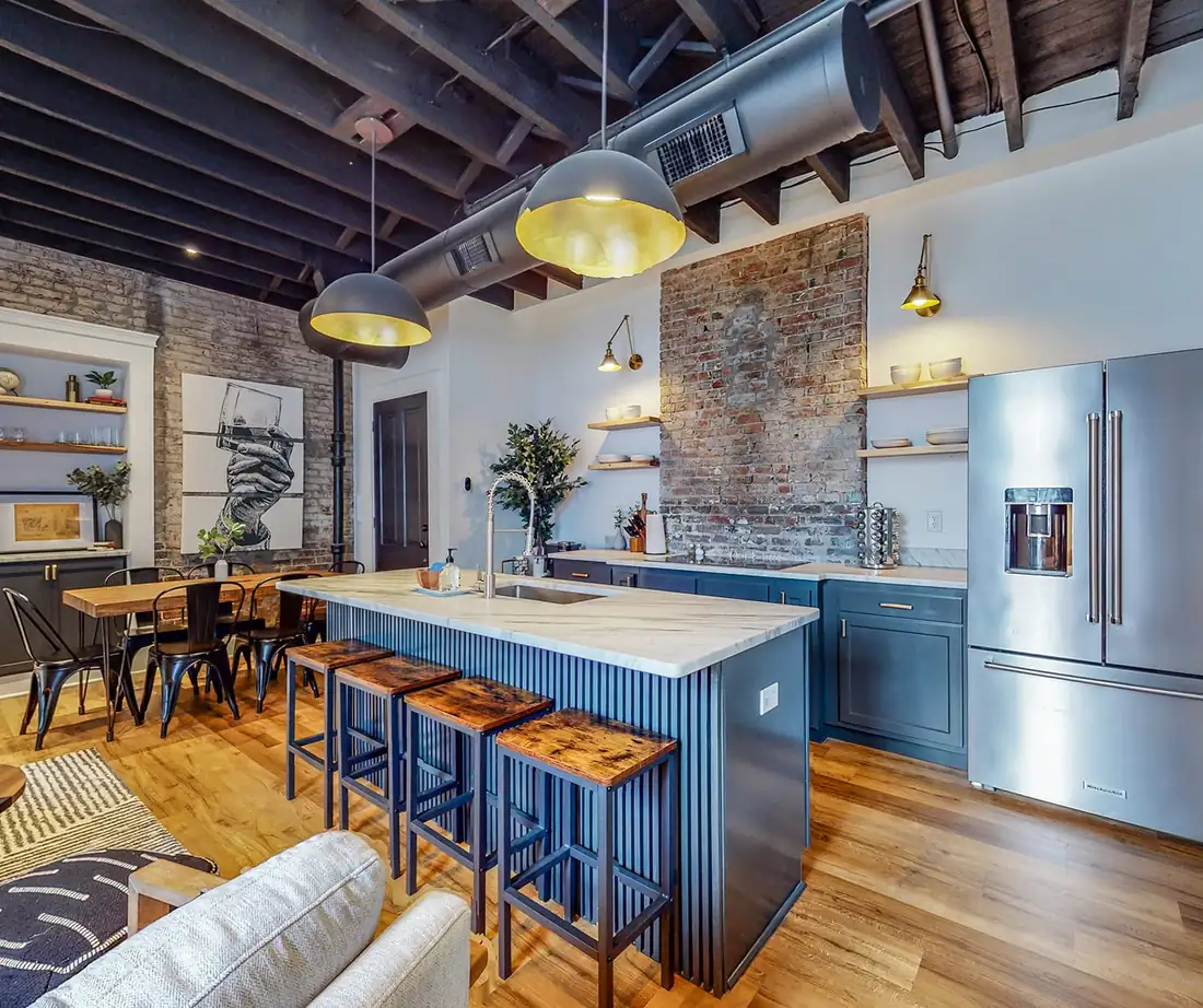 Exposed-brick loft kitchen in a Venturebnb-managed Louisville short-term rental